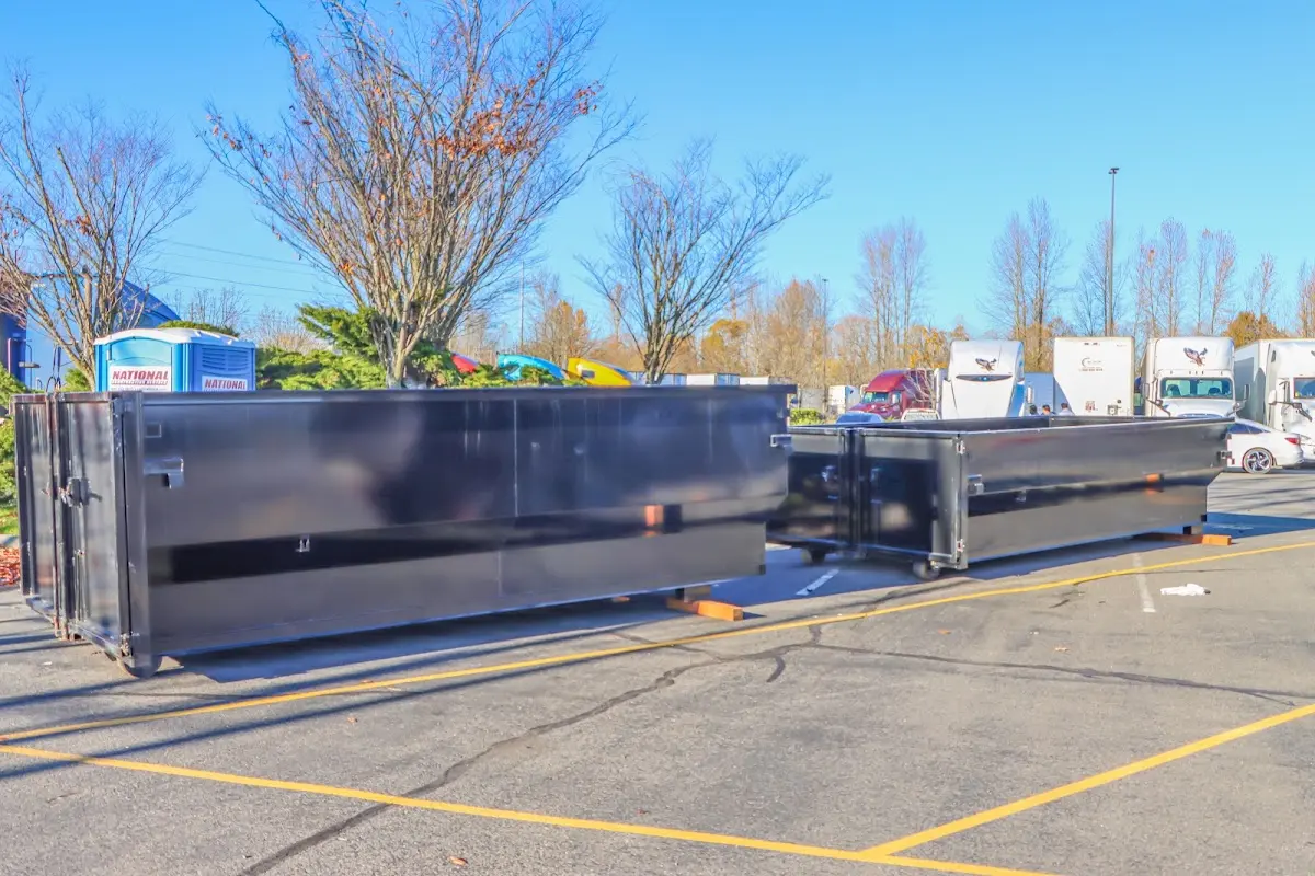 Professional dumpster rental service with roll-off container on residential driveway in Arden-Arcade